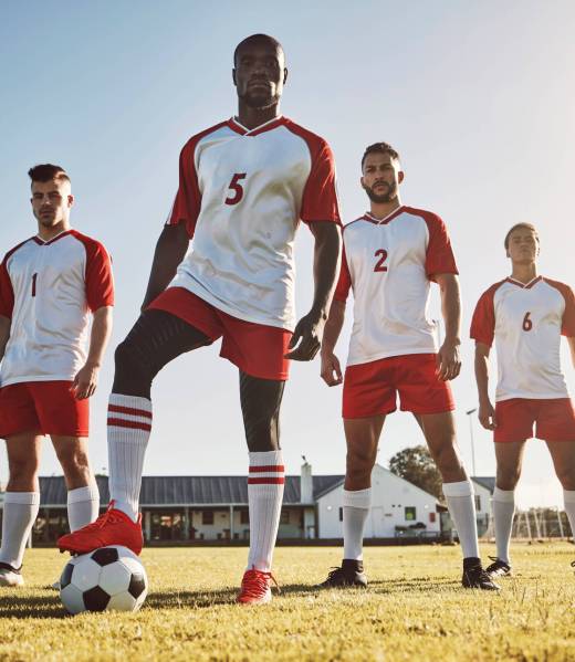 Men, soccer and team for game on sports field in fitness, exercise and training in the outdoors. Gr.